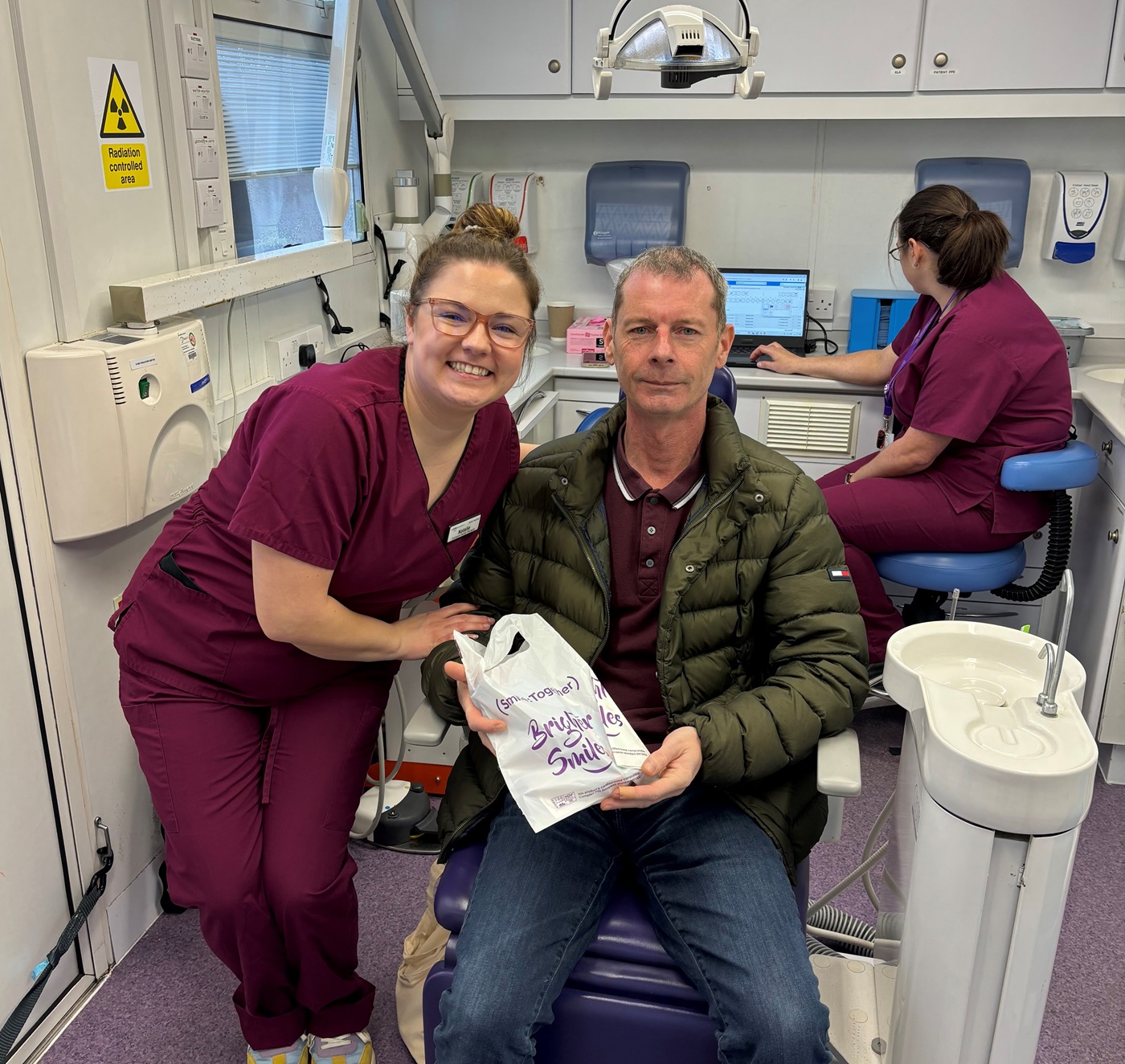 Dental therapist Natalie Peary  with Andrew, a smile together patient