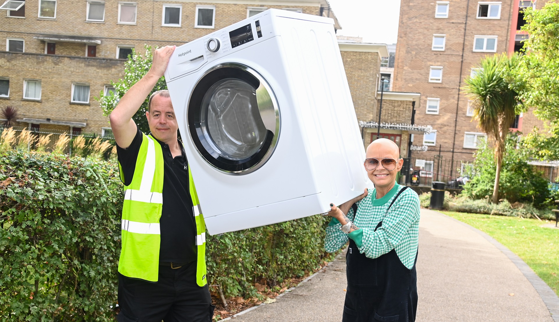 Getty photos of Gail Porter holding a washing machine aloft as she delivers item to a housing estate